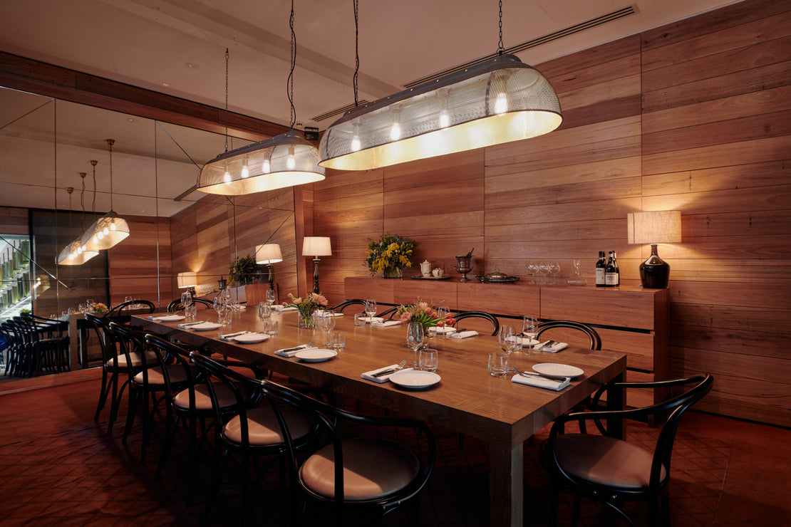 A table inside the Half Moon bar, set up to seat 12 people. There are no people in this image. 