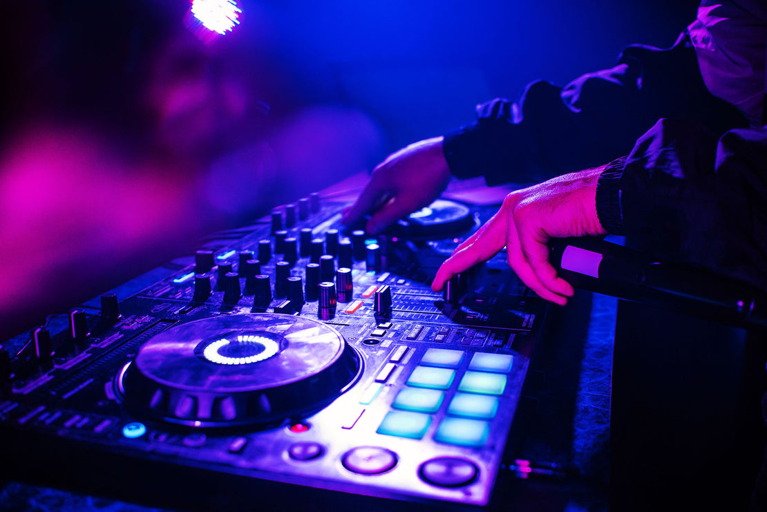 Close up on DJ's hands using DJ mixer deck. 